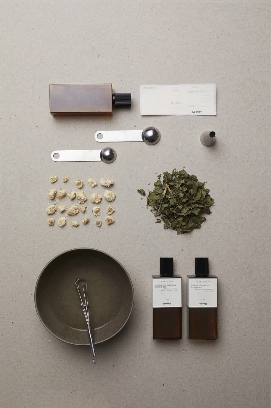 Apothecary flat lay of amber vials and herbs