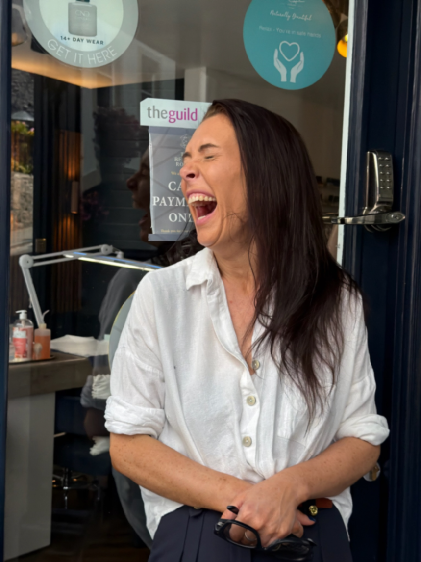 Ella laughing on the doorstep of Skin and Tonic